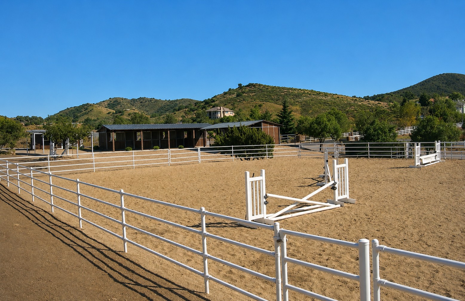 Riding arena with white rail fencing